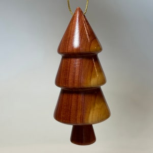 Christmas tree ornament. Turned from upcycled Texas wood. Looks great hanging from a tree or door handle. Sure to make you smile.