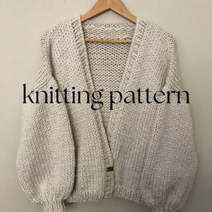 May include: A cream-coloured knitted cardigan with a button fastening and long sleeves. The cardigan has a relaxed fit and a slightly oversized silhouette. The text "knitting pattern" is visible in the image.