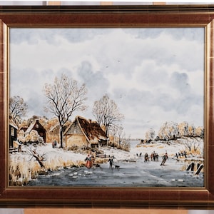 May include: A watercolor painting depicting a winter scene with a frozen lake and people ice skating. The painting features a small village with houses and trees in the background. The sky is a light blue with white clouds.