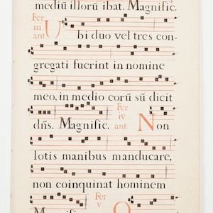 May include: A page from a vintage music manuscript with handwritten text and musical notation. The text reads "mediu illoru ibat. Magnific. Fer iii ant bi duo vel tres con- gregati fuerint in nomine meo, in medio eoru su dicit Fer iv dns. Magnific. ant Non lotis manibus manducare, non coinquinat hominem Fer v Magnific. ant Omnes qui".