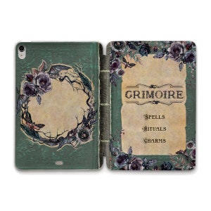 May include: A green and black phone case with a floral design and the word "Grimoire" on the front. The case also includes the words "Spells", "Rituals", and "Charms".