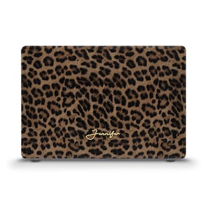 May include: A laptop case featuring a brown and black leopard print design. The name "Jennifer" is written in gold script across the bottom of the case. The case is rectangular and has a smooth finish.