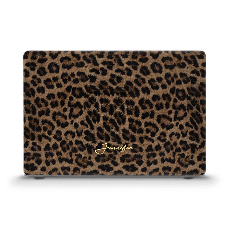 May include: A laptop case featuring a brown and black leopard print design. The name "Jennifer" is written in gold script across the bottom of the case. The case is rectangular and has a smooth finish.