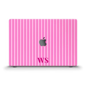 May include: A laptop skin featuring a pattern of vertical light pink and dark pink stripes. The center of the skin displays a dark gray Apple logo, and below the logo, the capital letters WS are printed in a bold, dark pink serif font.