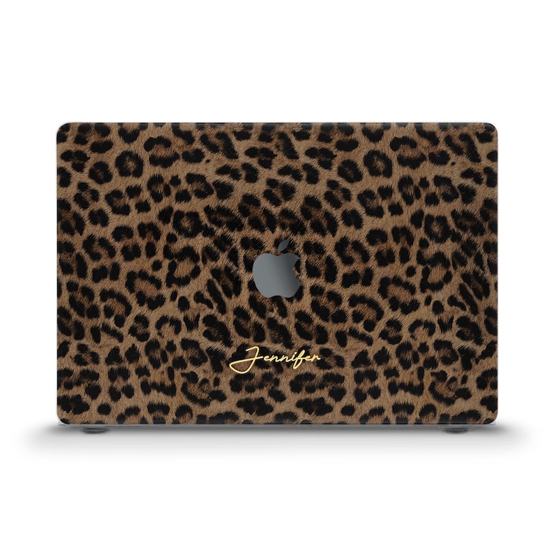 May include: A laptop case featuring a leopard print design in shades of brown and black. The Apple logo is visible, and the name "Jennifer" is written in gold script.