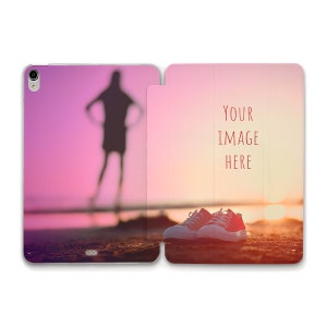 May include: A pink and orange sunset over a beach with a pair of white sneakers and the text "YOUR IMAGE HERE" on the right side of the image.