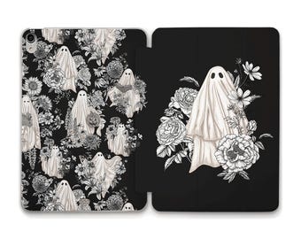 May include: Black and white iPad case with a pattern of ghosts and flowers. The case has a flap that covers the screen.
