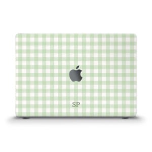 May include: A laptop skin featuring a light sage green and white gingham check pattern. The design includes a centered Apple logo cutout and the letters SP printed in a dark green serif font positioned directly below the Apple logo.