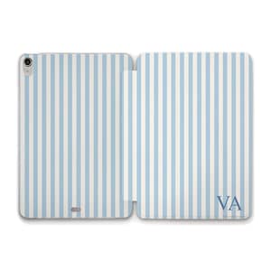 May include: A light blue and white striped tablet case, open to display the interior. The case features vertical stripes and the initials "VA" in the lower right corner. The case is designed to protect a tablet.