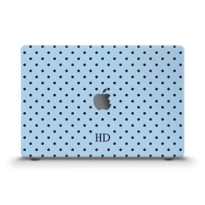 May include: A light blue laptop skin featuring a repeating pattern of small dark navy blue polka dots. The center of the skin displays a silver Apple logo, and the letters HD are printed in a dark navy blue serif font below the logo.