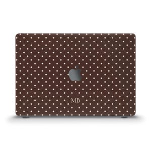 May include: A dark brown laptop skin featuring a repeating pattern of small, light-colored polka dots. The center of the skin displays a cutout for the Apple logo and the letters MB printed in a simple, light-colored serif font below the logo.