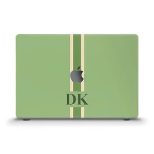 May include: A light green laptop with a vertical beige stripe down the center and two parallel stripes. The Apple logo is visible, along with the initials "DK" in a bold, dark font.