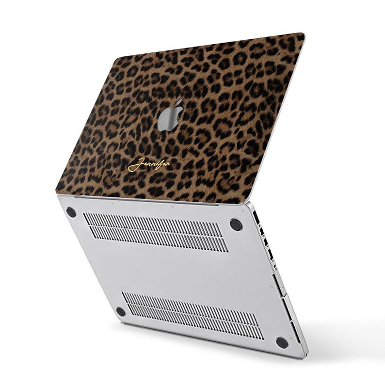 May include: A laptop with a leopard print cover. The cover features a brown and black spotted pattern with the name "Jennifer" in gold script. The laptop is silver with the Apple logo visible.