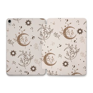 May include: A white tablet case with a beige background and a repeating pattern of brown crescent moons, stars, suns, and floral sprigs.