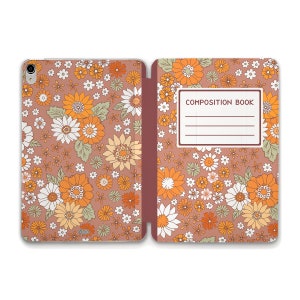 May include: A pink floral patterned composition book with the text "COMPOSITION BOOK" on the front cover.