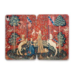 May include: Tablet case featuring a medieval tapestry design with a red background. The tapestry depicts a lion, a unicorn, and figures in medieval attire, holding flags with crescent moons. Trees, animals, and birds are also visible in the detailed artwork.