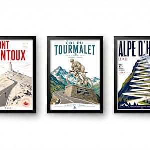 May include: Three framed posters featuring cycling mountain climbs in France. The first shows Mont Ventoux with a red title. The second depicts the Col du Tourmalet with a cyclist statue. The third displays Alpe d'Huez with its winding road.