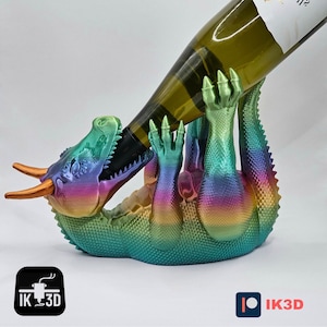 May include: A rainbow iridescent dragon-shaped wine bottle holder. The dragon is holding a bottle of wine in its mouth.
