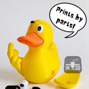 May include: A bright yellow duck toy with an orange beak and a raised finger. The duck has a speech bubble that says "Prints by parts!". The image also includes the "IK 3D" logo and some detached parts.
