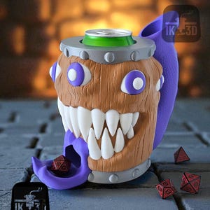 May include: A novelty mug with a monster design, featuring a brown wooden texture, white teeth, and purple eyes. A green can is placed in the top, and a purple tongue holds a red die. The mug has a silver band and a purple handle.