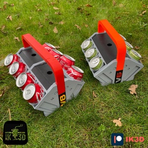 May include: Two gray and orange plastic beverage carriers with red handles. Each carrier holds six cans. The carriers are labeled "V6" and "B8".