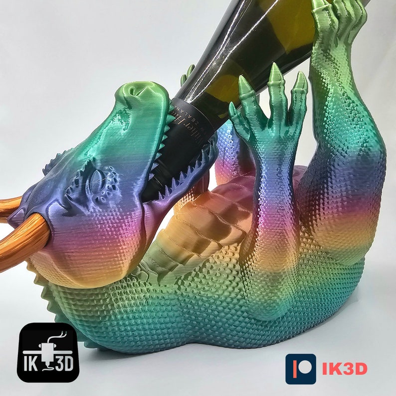 May include: A rainbow iridescent dragon-shaped wine bottle holder. The dragon is holding a wine bottle in its mouth.