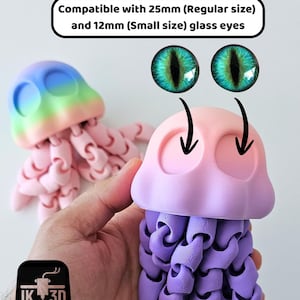 May include: Two 3D-printed jellyfish toys in pink, purple, and blue hues. The jellyfish have articulated tentacles and are designed to accommodate 25mm and 12mm glass eyes. The image includes the text "Compatible with 25mm (Regular size) and 12mm (Small size) glass eyes."