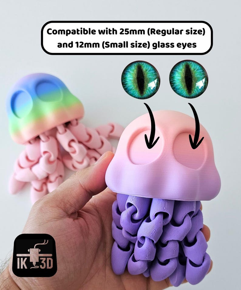 May include: Two 3D-printed jellyfish toys in pink, purple, and blue hues. The jellyfish have articulated tentacles and are designed to accommodate 25mm and 12mm glass eyes. The image includes the text "Compatible with 25mm (Regular size) and 12mm (Small size) glass eyes."