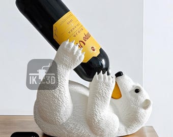 May include: White ceramic polar bear wine bottle holder with a bottle of red wine in its mouth. The bottle label reads "Rioja Odum", "Crianza", and "2020".