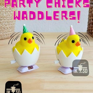 May include: Two yellow chick wind-up toys wearing party hats. The chicks are in white egg shells and have black eyes. The toys are on a wooden surface. The text "Party Chicks Waddlers!" is in pink letters on a white background.