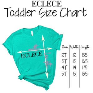 May include: A turquoise toddler t-shirt with a white graphic of a compass with the words "ECLECE" and "width" and "length" written on it. A size chart is shown with the sizes 2T, 3T, 4T, and 5T, with corresponding width and length measurements in inches.