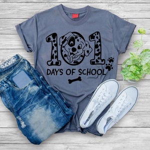 May include: A grey t-shirt with a black and white dalmatian dog graphic. The graphic says "101 Days of School" with a bone underneath.