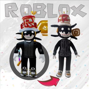May include: Two crocheted Roblox character plush toys. The toy on the left is wearing a black and white outfit with a red heart on the chest and a birthday hat with candles. The toy on the right is wearing a black and white outfit with a birthday hat with candles. The toys are facing forward and are standing on a white background.