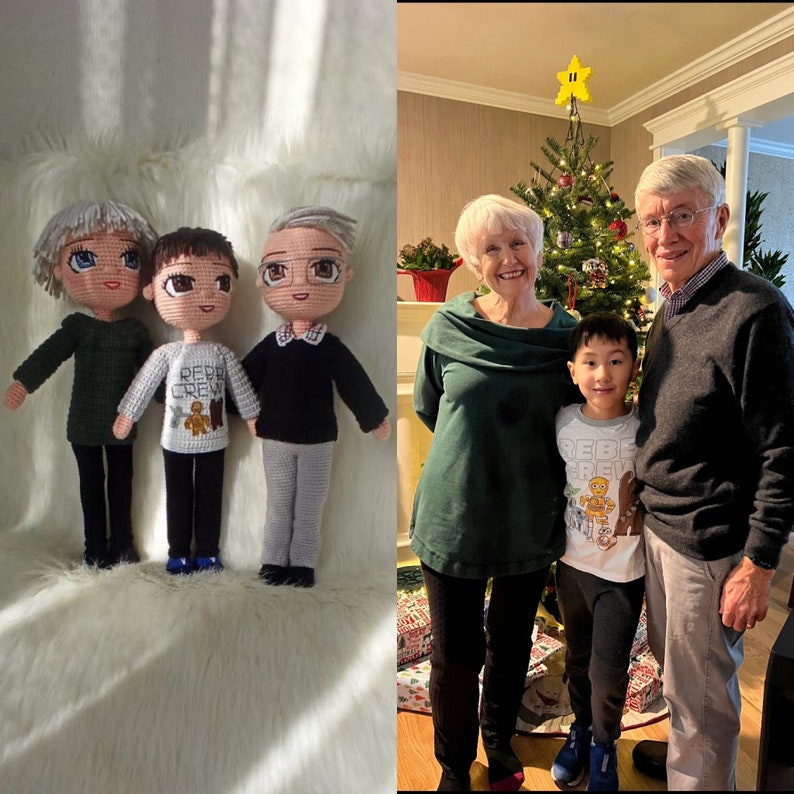 May include: Three crocheted dolls, a woman, a man, and a child, stand in front of a white fuzzy surface. The dolls are dressed in casual clothing. The woman, man, and child are standing in front of a Christmas tree.
