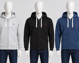 May include: Three zip-up hoodies in light gray, black, and navy blue. Each hoodie features a drawstring hood, a front zipper closure, two front pockets, and a small embroidered logo on the left chest. The hoodies are worn over dark blue jeans.