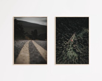 May include: Two framed photographs of a winding road through a forest. The first photo shows a close-up of the road with two yellow lines down the center. The second photo shows an aerial view of the road winding through a dense forest.