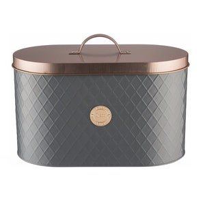 May include: A grey oval bread bin with a copper-coloured lid and handle. The bin features a diamond pattern and a gold-coloured label with the word "Friend". The lid is curved, and the handle is arched. The bread bin is designed for kitchen storage.