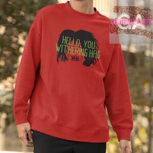 May include: Red sweatshirt with a black silhouette of a woman's head and the text "HELLO, YOU WITHERING HAG" in green.