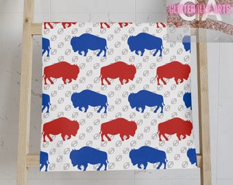 May include: White fabric with a repeating pattern of blue and red buffalo silhouettes and white footballs.