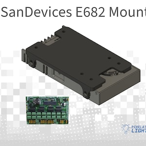 May include: A black metal mounting bracket for a SanDevices E682 device. The bracket has a rectangular shape with several holes for mounting screws. A green circuit board with multiple connectors is visible in the background.