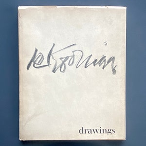 May include: A white book cover with the text "drawings" printed in black at the bottom. The book cover has a handwritten signature in black ink that reads "Klee"