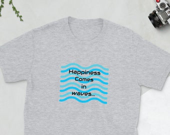 May include: A light gray t-shirt with the text "Happiness Comes in waves..." in a blue wave design. The shirt is made of a soft material and is suitable for casual wear. The shirt is a unisex style.