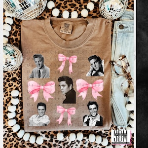 May include: A brown t-shirt featuring a graphic of Elvis Presley with pink bows. The text "Do Not Copy Do Not Copy" is repeated on the shirt.