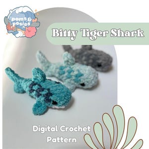 May include: Three crocheted shark toys in shades of blue and gray. The front shark is teal with dark blue markings. The text "Bitty Tiger Shark" and "Digital Crochet Pattern" are visible.