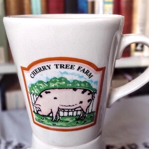 May include: White ceramic mug with a cartoon pig illustration and the text "Cherry Tree Farm".