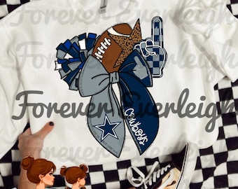 May include: White sweatshirt featuring a football, bow, and foam finger design. The bow has a star and the word "Cowboys" on it. The design incorporates blue, gray, and brown colors, perfect for football fans.