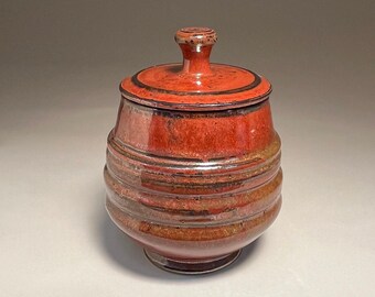 Covered jar, 7 inches tall, stoneware with red glaze