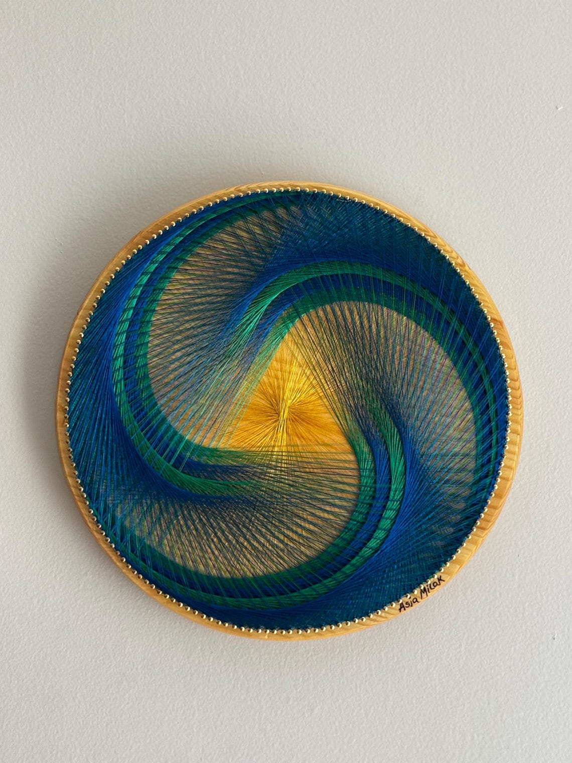 Geometric Spiral String Art: Blue, Green, and Yellow Fiber Wall Hanging ...