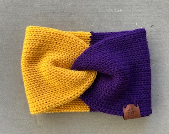May include: A yellow and purple knitted headband with a brown leather tag that says "I&T".