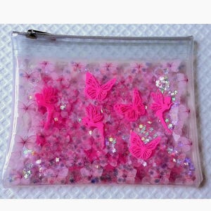 Grande pochette cosmétique liquide à paillettes. Trousse à maquillage avec papillons et fées roses fluo + flotteur irisé irisé scintillant dans un design imprimé